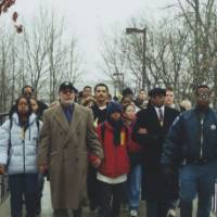 Students and family walk across the Little Mac Bridge.